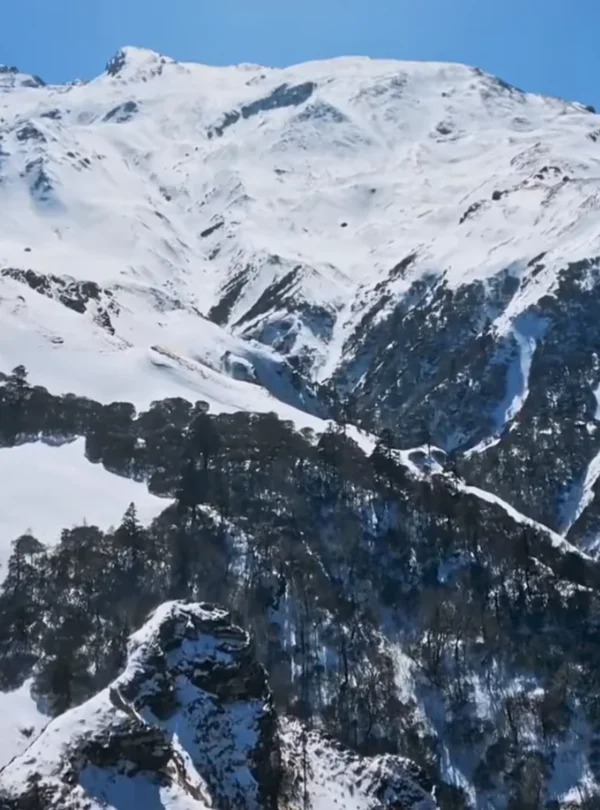 Trekkers on snow ridge near Kuari Pass summit