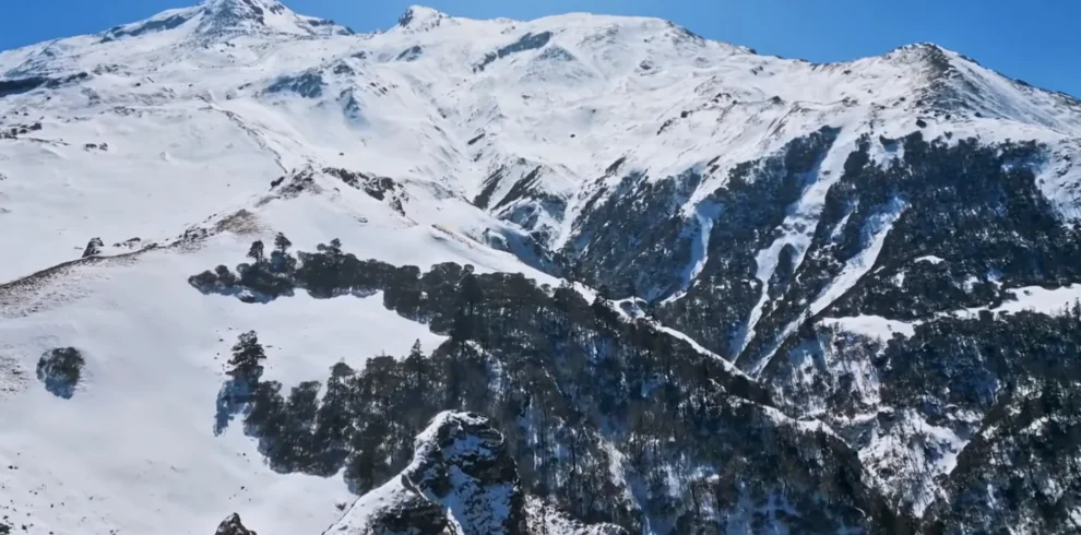 Trekkers on snow ridge near Kuari Pass summit