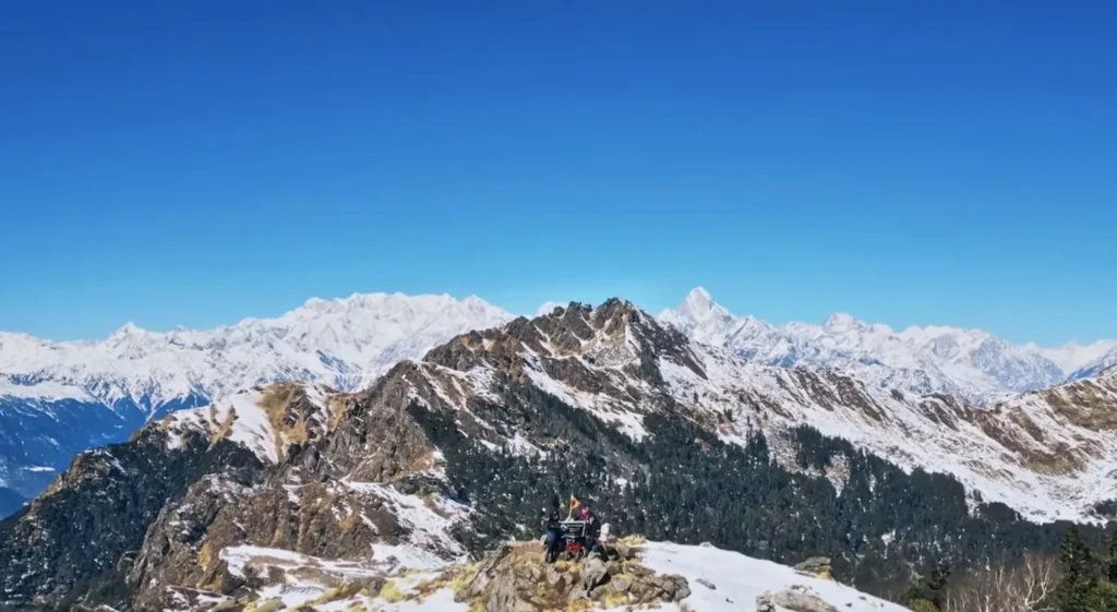 Trekkers walking on snow trail, Pangarchulla peak trek